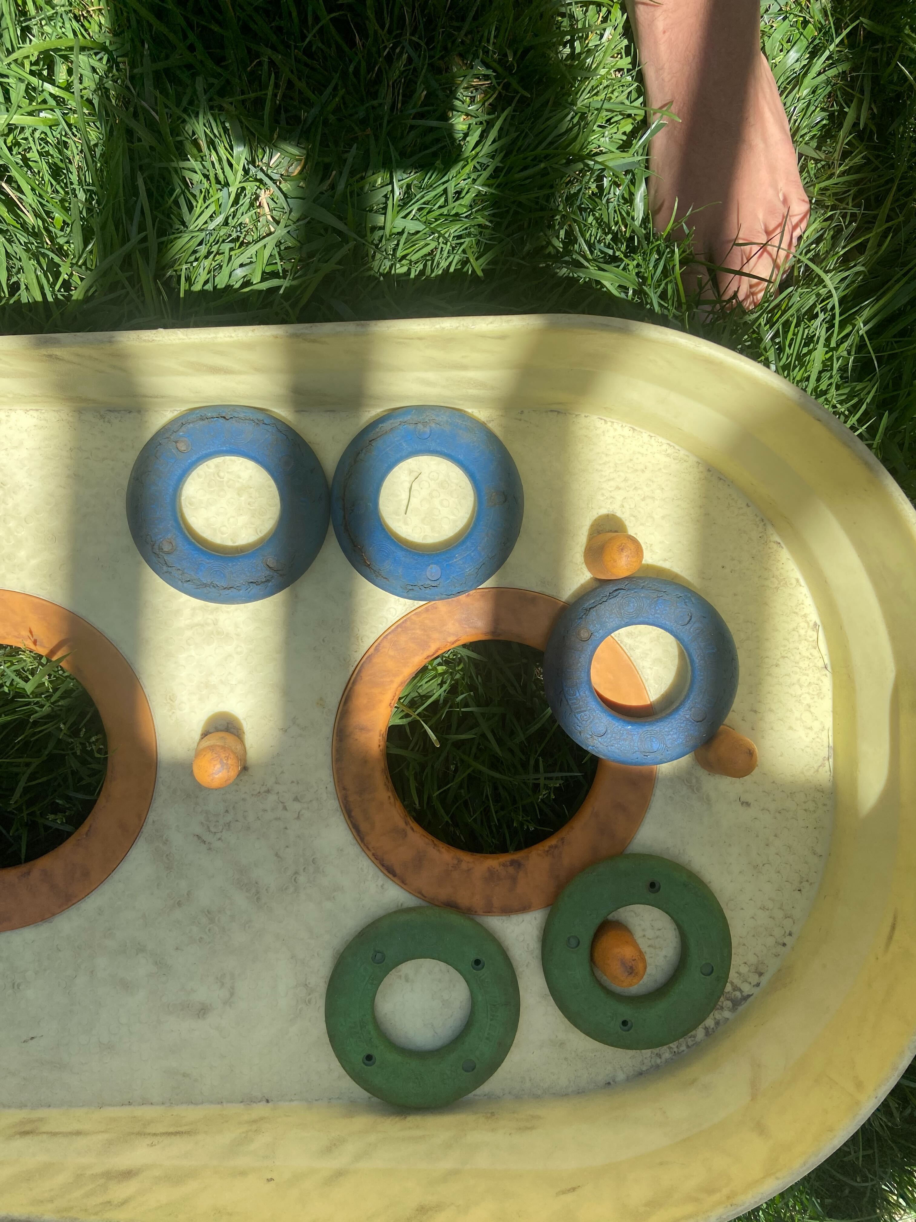 Chuckers board with rings scattered across the scoring holes.